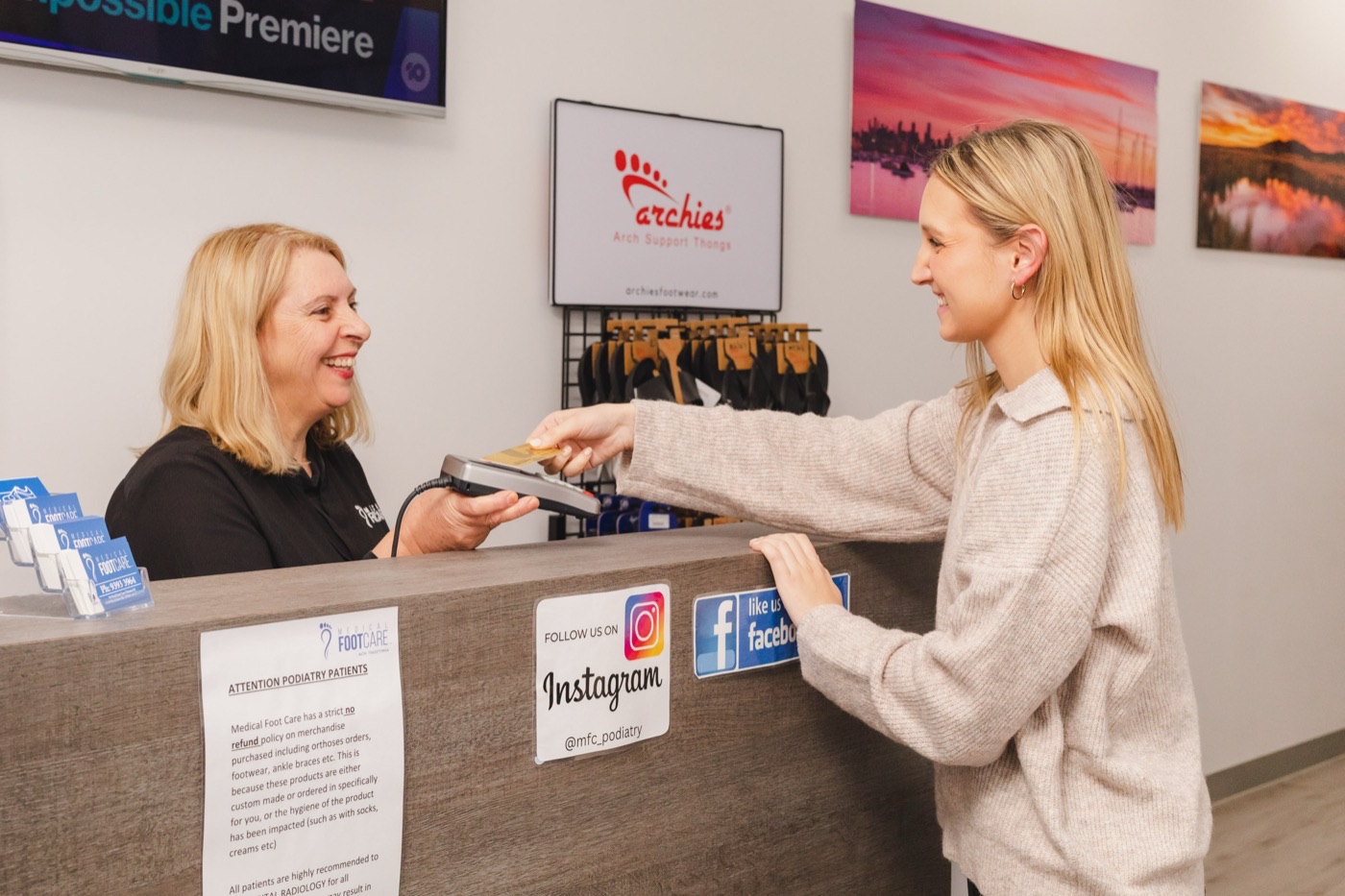 A patient paying at the Medical Foot Care reception desk
